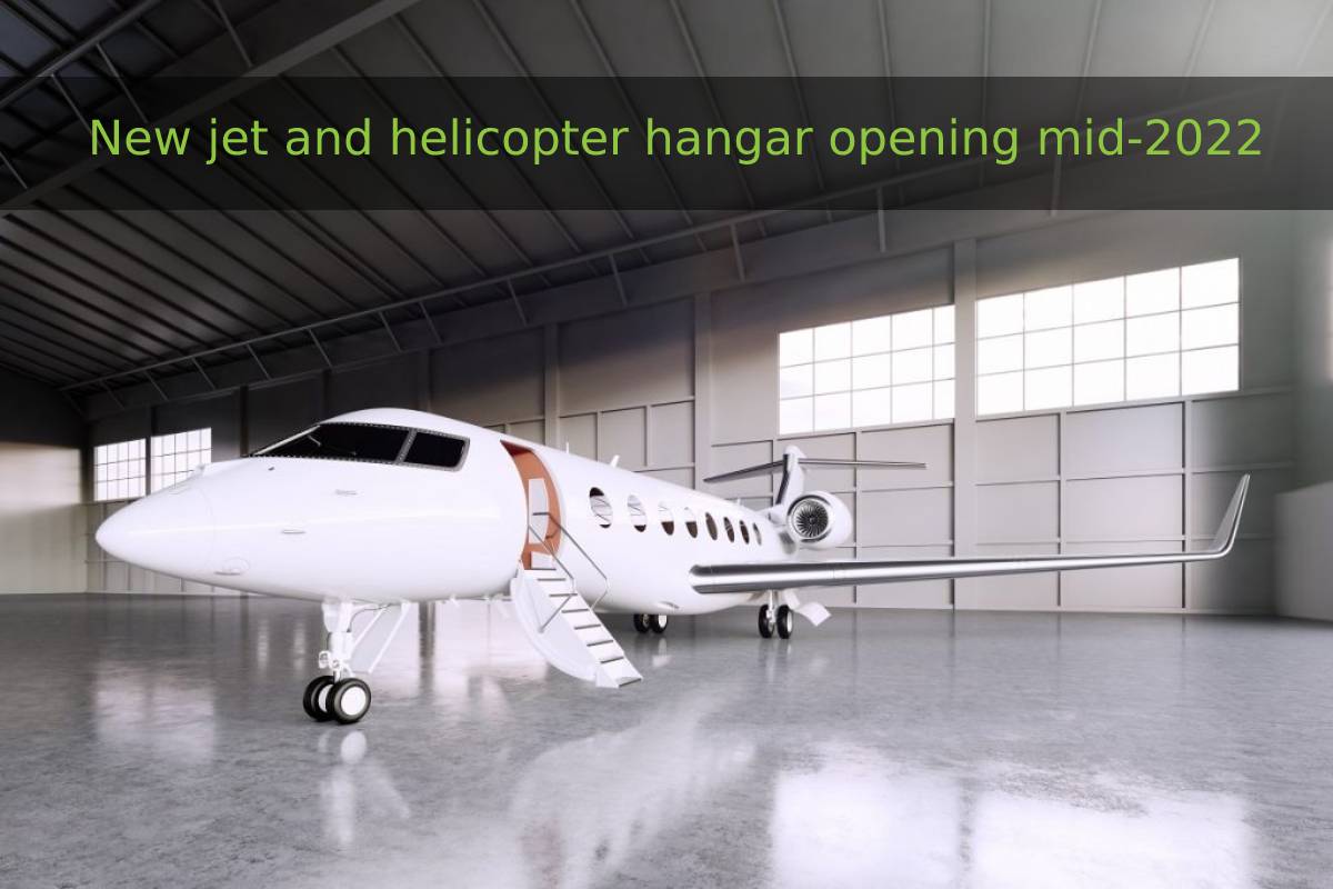 Private jet in a hangar with banner text 'New jet and helicopter hangar opening mid-2022